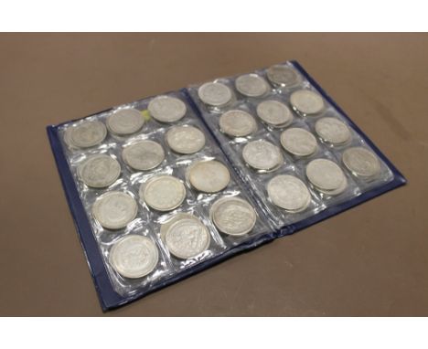 A COLLECTION OF VINTAGE WHITE METAL WORLD COINS