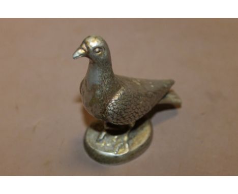 A VINTAGE WHITE METAL PIGEON CAR MASCOT