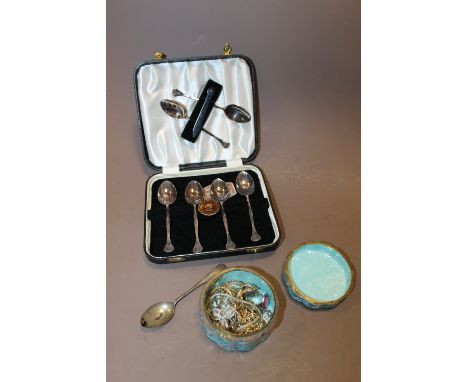 A CASED SET OF SIX TEASPOONS + A HALLMARKED SILVER EXAMPLE + A VINTAGE ENAMEL LIDDED POT OF COSTUME JEWELLERY