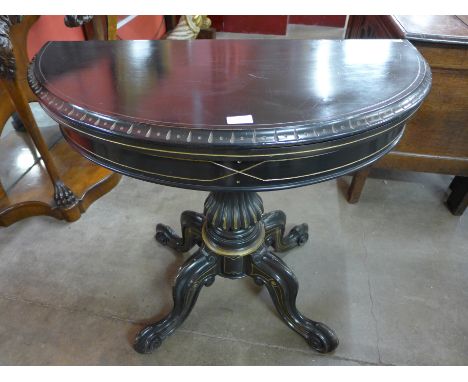 A Victorian Aesthetic Movement ebonised and parcel gilt demi lune card table