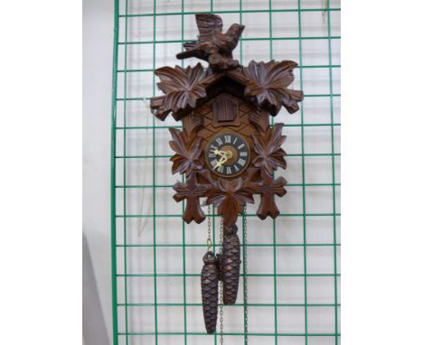 A Black Forest cuckoo clock and a 19th Century cast iron mantel timepiece