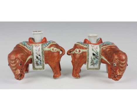 A pair of Chinese Canton famille rose export porcelain candlestick figures of elephants, mid-19th century, each iron red and 