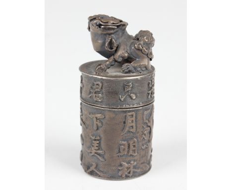 A Chinese silver cylindrical box desk seal, early 20th century, the screw cover with Buddhistic lion finial, the sides decora