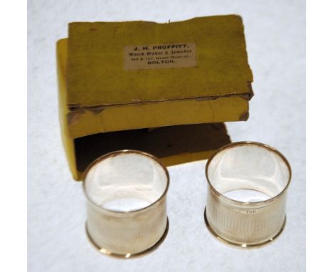 BOXED PAIR OF GEORGE V ENGINE TURNED SILVER BROAD NAPKIN RINGS, Birmingham 1919, 1oz (box a.f.) 