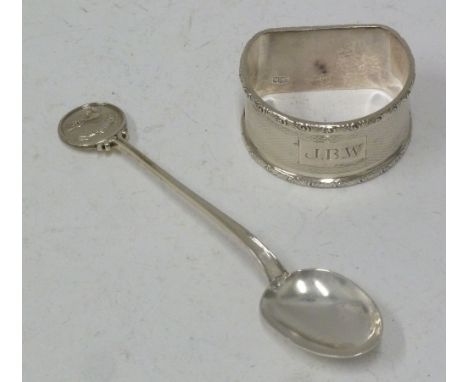 D SHAPED SILVER NAPKIN RING, with foliate scroll border and engine turned decoration and a SOUVENIR SMALL SPOON, the disc fin