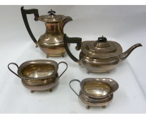 FOUR PIECE SILVER TEA AND COFFEE SERVICE of rounded oblong form with beaded rims, blackwood handles and knops, each standing 