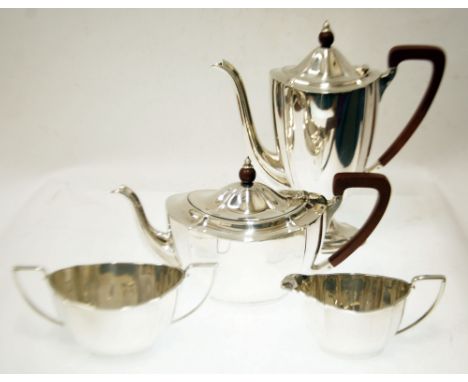 EARLY 20th CENTURY SILVER FOUR PIECE TEA AND COFFEE SERVICE each of shaped oval form, the tea and coffee pots with redwood ha