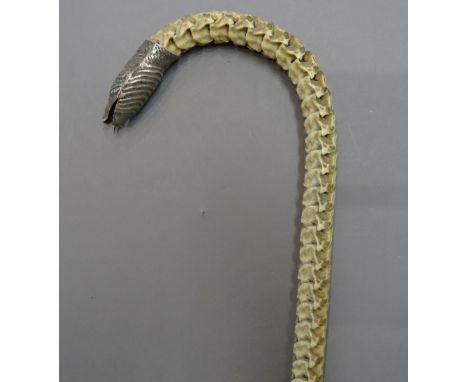 A rare silver mounted snake vertebrae walking stick, late 19th century, with silver serpent head finial, 94cm.