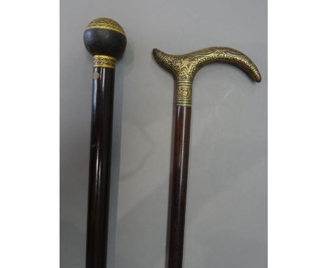 A Damascene gilt Toledo walking cane, early 20th century, with a spherical pommel and hardwood cylindrical shaft (92cm) and a