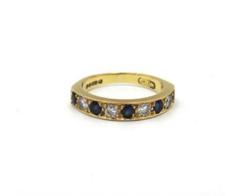 An 18ct gold, sapphire and diamond nine stone half hoop eternity ring, mounted with five circular cut sapphires, alternating 