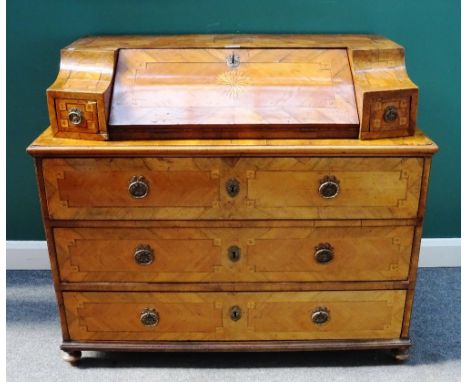 An 18th century South German marquetry inlaid bureau commode, the slope front superstructure flanked by drawers, the base wit