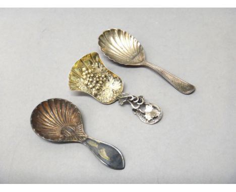 A Victorian silver gilt tea caddy spoon, the shovel shaped bowl embossed with fruiting vine, the handle of entwined vine leaf