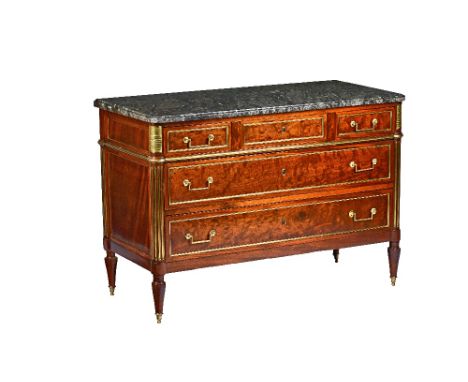 A Louis XVI style commode circa 1900, the rectangular marble top over a gilt metal mounted mahogany base of three short and t
