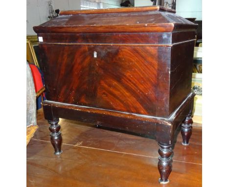 An early 19th century mahogany cellarette, with rectangular caddy top on turned supports, 55cm wide x 61cm high x 35cm deep. 