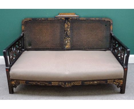 A 20th century black lacquer and chinoiserie decorated three piece suite with cane back and cockpen sides, sofa 141cm wide x 