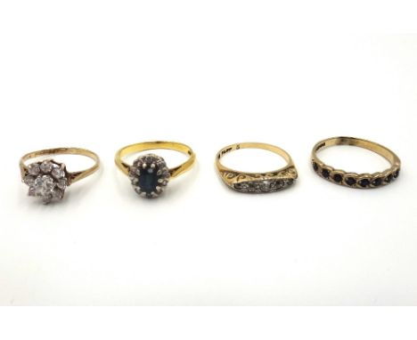 A gold and platinum, diamond set five stone ring, set with cushion shaped diamonds, in a boat shaped setting, a gold, sapphir