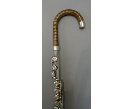 A novelty 'flute' walking stick, with bamboo handle and white metal mounts, 96cm.