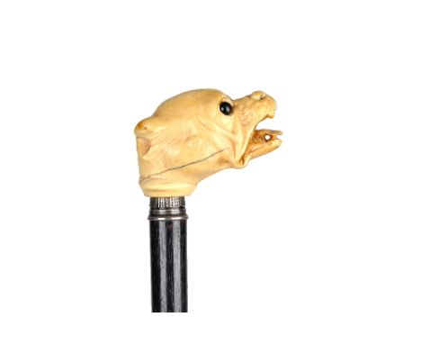 A Victorian ivory and ebonised walking cane, the carved ivory bull dog's head pommel with inset glass eyes and a hallmarked s