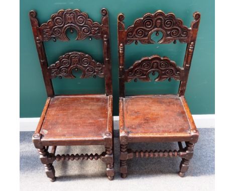 Two similar sets of four Charles II style oak dining chairs, with carved and shaped double ladder back, over solid seat, on b