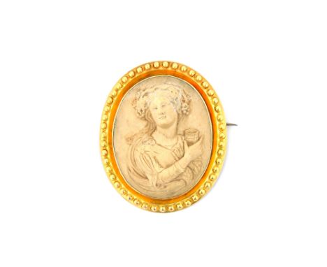 A Victorian gold mounted oval lava cameo brooch, carved as a classical female figure within a beaded surround and a pair of V