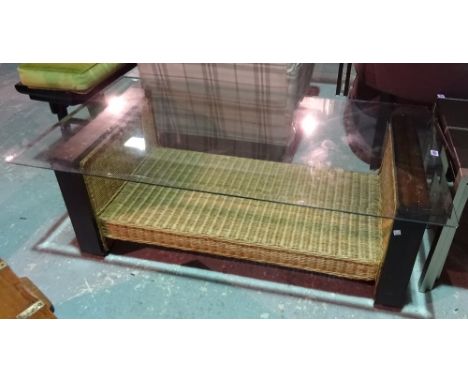 A 20th century rectangular glass top coffee table on mahogany and rattan base, 128cm wide x 44cm high. 