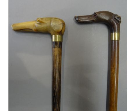 A horn mounted dog's head walking stick, late 19th century, with inset glass eyes on a hardwood cylindrical tapering shaft (8