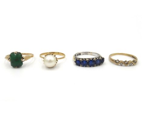 A gold and sapphire five stone ring, mounted with a row of graduated cushion shaped sapphire and with four pairs of rose diam