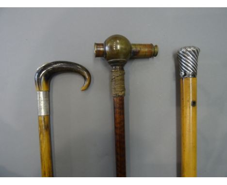 A Victorian brass 'telescope' gadget cane, with a rope bound collar and patterned shaft (93cm), a silver topped malacca cane 