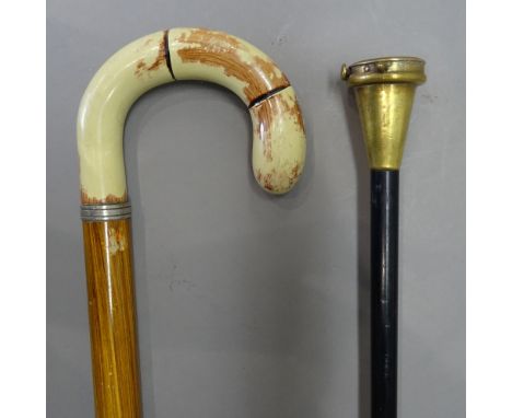 A brass mounted 'tape measure' gadget walking cane, early 20th century, on an ebonised cylindrical shaft (92cm) and one furth