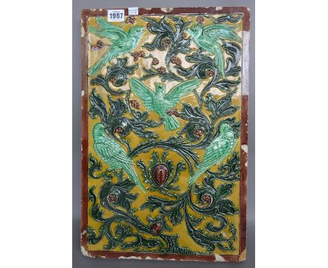 A Chinese style majolica pottery tile, 20th century, relief decorated with birds amongst foliage, 47cm x 31cm. 