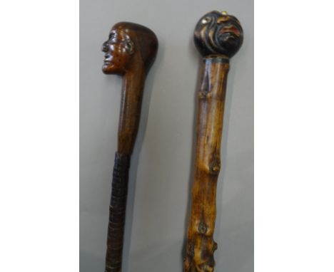 An unusual carved wood and leather bound walking stick, 19th century, the pommel carved as a man's head over a shaft decorate