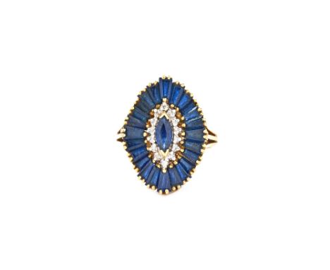 An 18ct gold, sapphire and diamond cluster ring, mounted with a marquise shaped sapphire to the centre, in a surround of circ