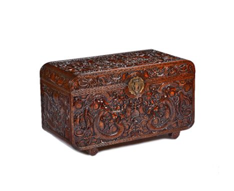 A late 19th/early 20th century Chinese hardwood trunk, extensively carved with dragons, 90cm wide x 53cm high x 43cm deep. Il