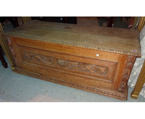 A late 19th century carved faded oak cassone style trunk, 124cm wide x 46cm high. 