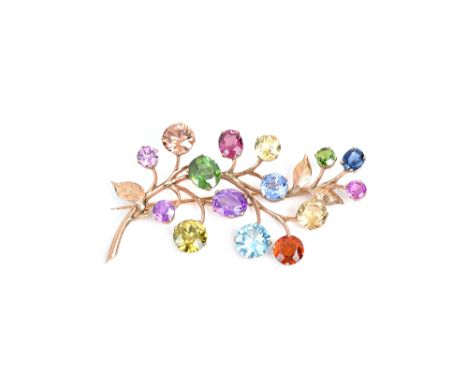 A gold and vary coloured gemstone set brooch, designed as a foliate spray, the gemstones including amethyst, pale brown zirco