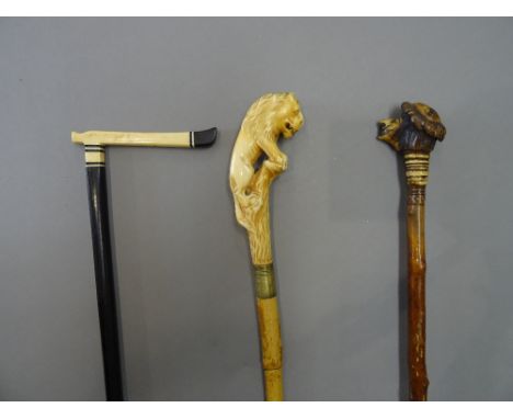 An antler mounted black thorn swagger stick, late 19th century, the antler pommel carved with a grotesque face (85cm), an Afr