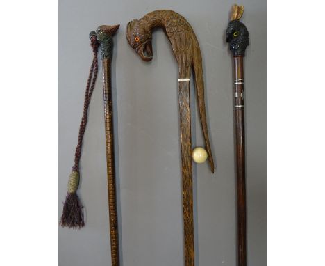 An unusual African ivory mounted walking stick, 19th century and later, the handle carved as a parrot over a tapering square 