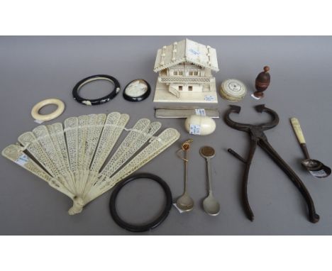 A group of small collectables including; Victorian ivory sewing accessories, teething ring, bangles, carved treen thimble cas