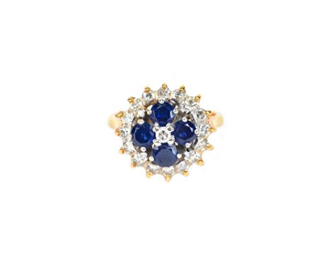 A gold, diamond and sapphire cluster ring, claw set with the principal circular cut diamond in a surround of four circular cu