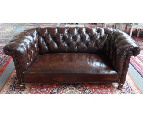 An early 20th century brown leather upholstered button back Chesterfield sofa on tapering square supports, 175cm wide x 70cm 