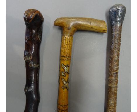 An Irish Shillelagh black thorn walking stick, with silver presentation plaque, dated 1894 (86cm), another carved wooden walk