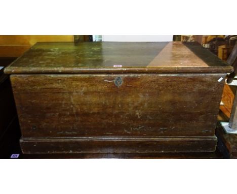 A 20th century stained pine lift top trunk, 70cm wide x 49cm high.