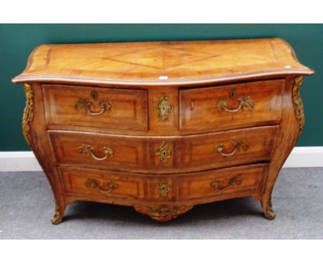 A Louis XV style gilt metal mounted walnut bombe commode of two short and two long drawers on splayed bracket feet, 132cm wid