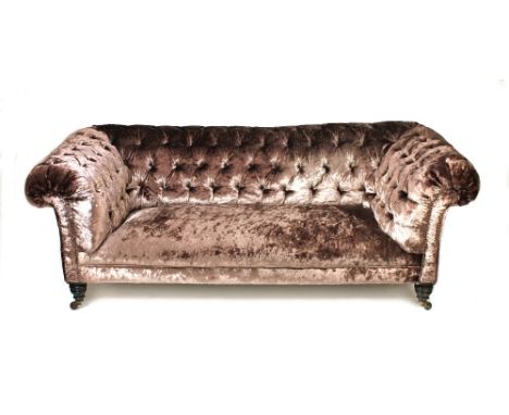 A Victorian low button back Chesterfield sofa, on turned walnut supports, 200cm wide x 72cm high x 100cm deep. 