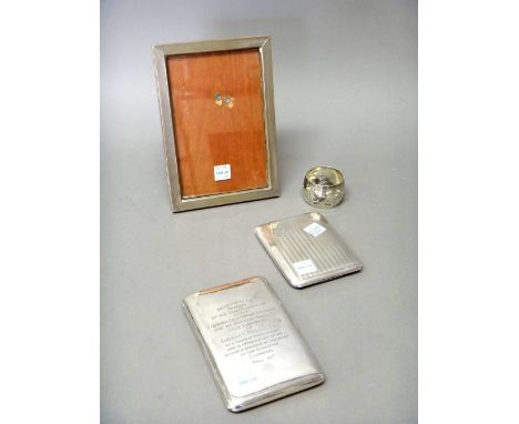 A silver rectangular cigarette case, presentation inscribed, Birmingham 1915, silver napkin ring with pierced decoration, Bir