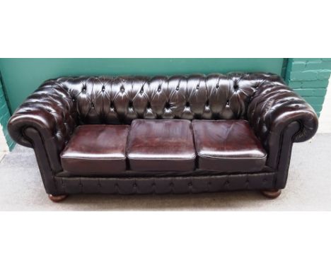 A 20th century brown leather button upholstered Chesterfield sofa, with rollover arms, 195cm wide x 95cm deep x 75cm high.