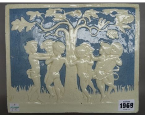 A Della Robbia style pottery plaque, late 19th century/20th century, depicting putti dancing around a tree, incised marks to 