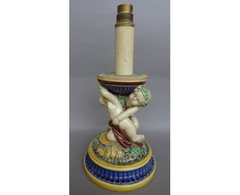 A Minton majolica table lamp base, late 19th century, moulded with putti  emblematic of the seasons on a fluted circular base