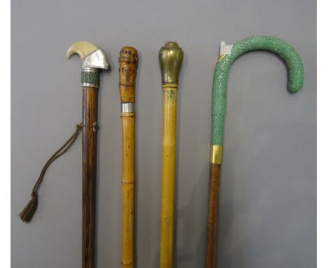 An early 20th century 'whistle' gadget cane with brass screw top pommel (88cm), a shagreen and leather bound walking stick wi