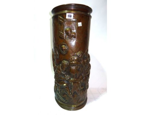 An early 20th century embossed copper cylindrical stick stand decorated with a tavern scene.  M8